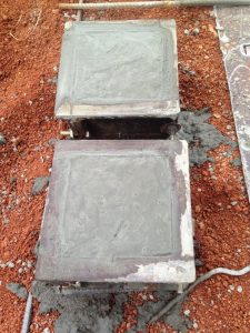 Adding concrete to cube moulds